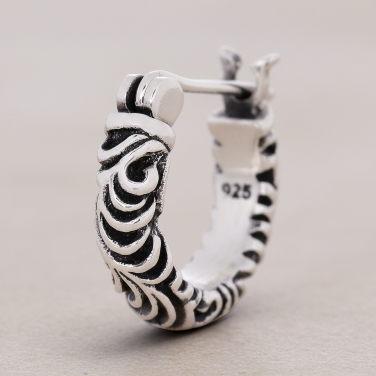Truelements Jewelry sterling silver hoop earring featuring detailed arabesque engravings and a 925 hallmark.