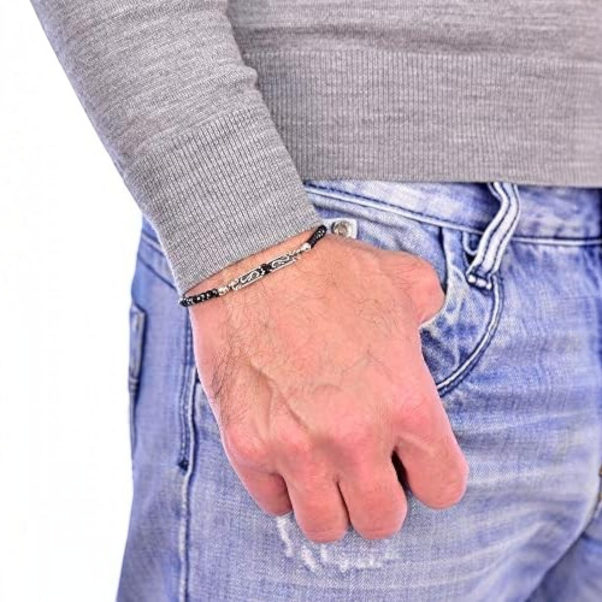 Truelements Jewelry sterling silver arabesque bracelet with black spinel beads worn on a man's wrist