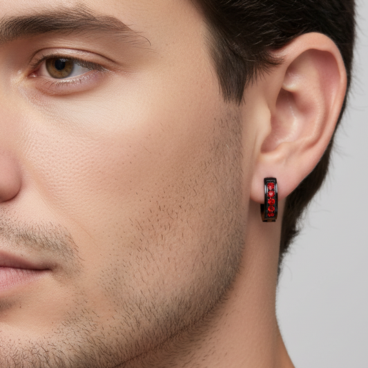 Truelements Jewelry men's black surgical stainless steel hoop earring with a 2mm red crystal worn on a model's ear