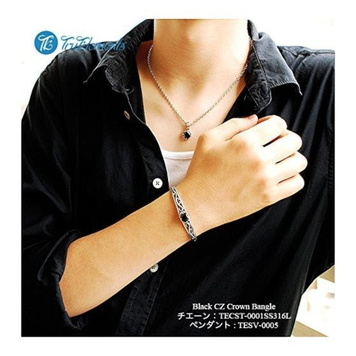 Truelements Jewelry sterling silver bangle with arabesque crown motif and black zirconia worn on a man's wrist