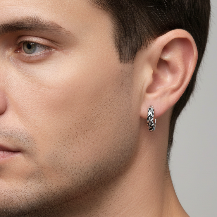 Truelements Jewelry sterling silver hoop earring with detailed arabesque engraving worn by a man in profile