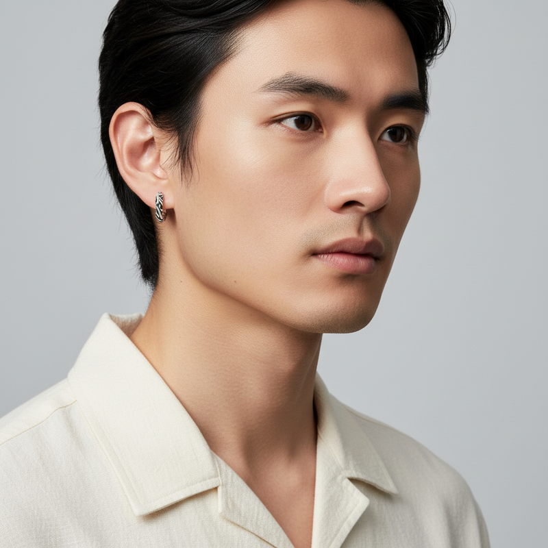 Truelements Jewelry silver 925 arabesque hoop earring with intricate engraved patterns worn by a man in a white shirt