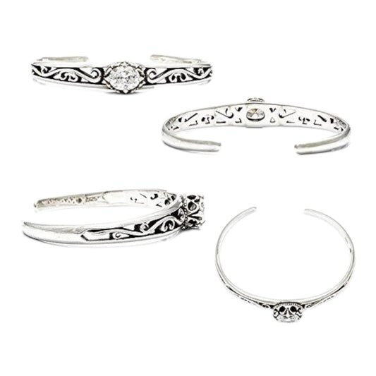 Truelements Jewelry sterling silver bangle with arabesque filigree, crown motif, and oval clear zirconia stone.