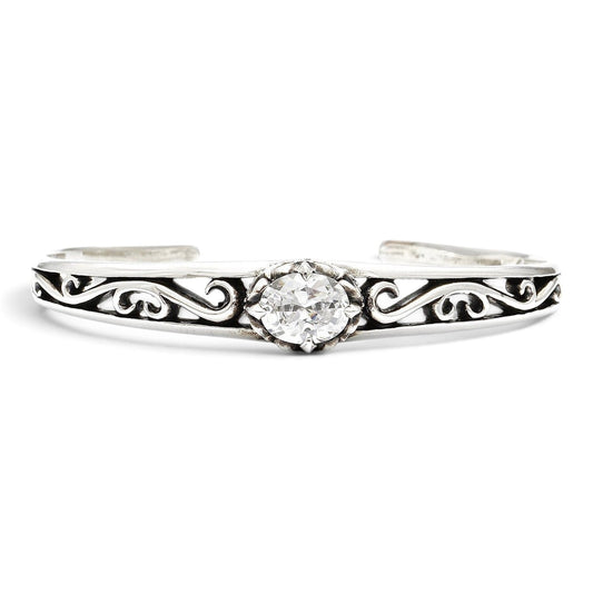 Truelements Jewelry sterling silver bangle featuring an arabesque crown motif and a central oval clear zirconia stone.