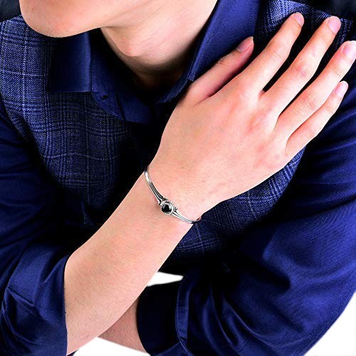 Truelements Jewelry sterling silver bangle with a black cubic zirconia stone worn on a man's wrist