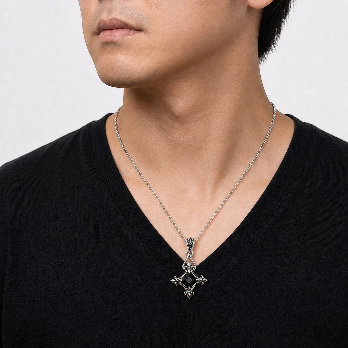 Truelements Jewelry sterling silver Byzantine cross pendant with black cubic zirconia worn on a silver anchor chain