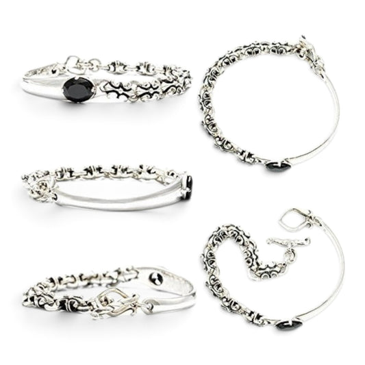 Truelements Jewelry sterling silver bangle featuring a black cubic zirconia stone and ornate fleur-de-lis motifs.
