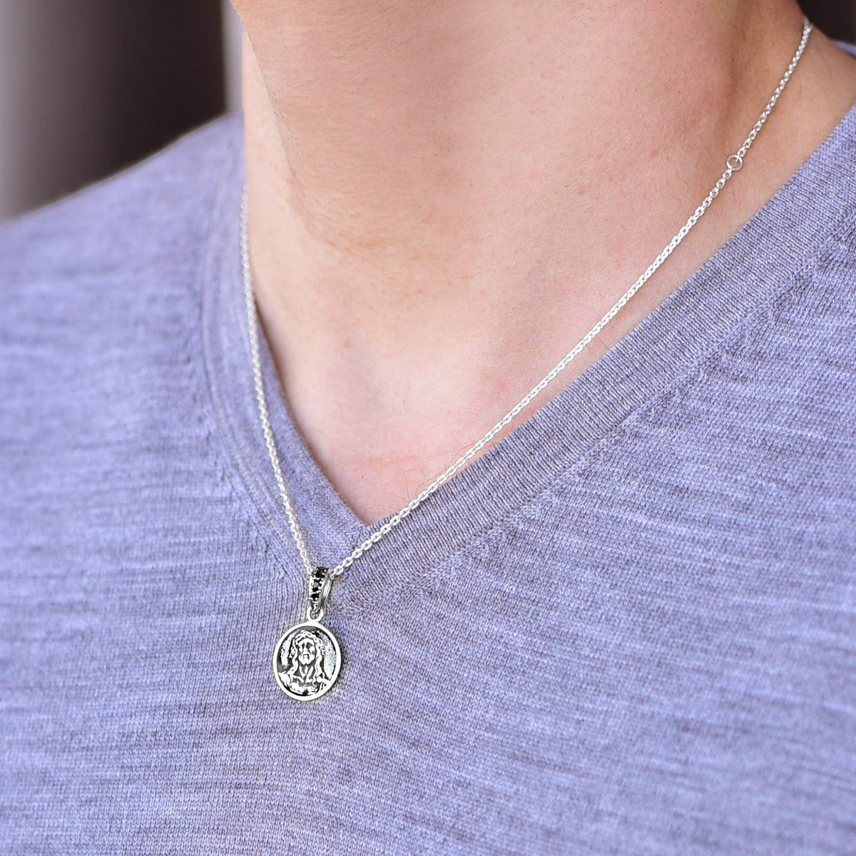 Truelements Jewelry sterling silver Jesus medallion pendant with black zirconia worn on a silver anchor chain