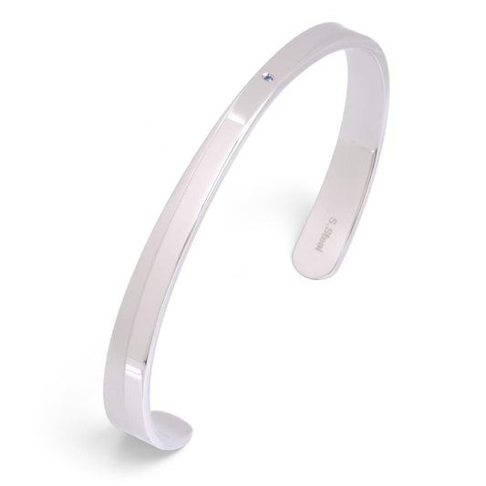 Truelements Jewelry men's silver 316L surgical stainless steel bangle featuring a small light blue sapphire stone.