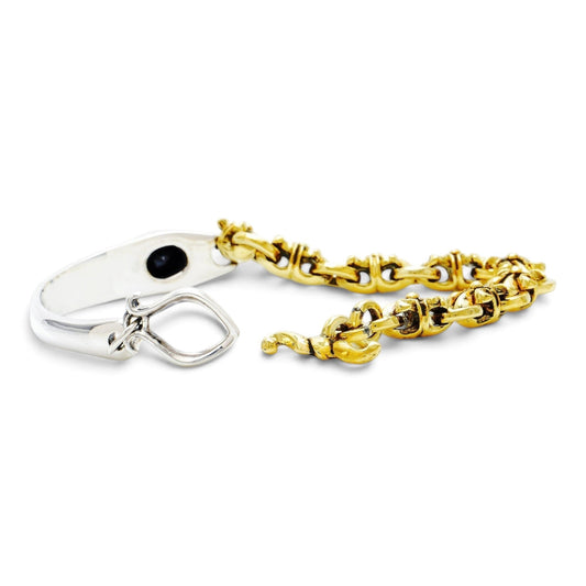 Truelements Jewelry two-tone bracelet in sterling silver and brass with Fleur-de-lis links and black cubic zirconia
