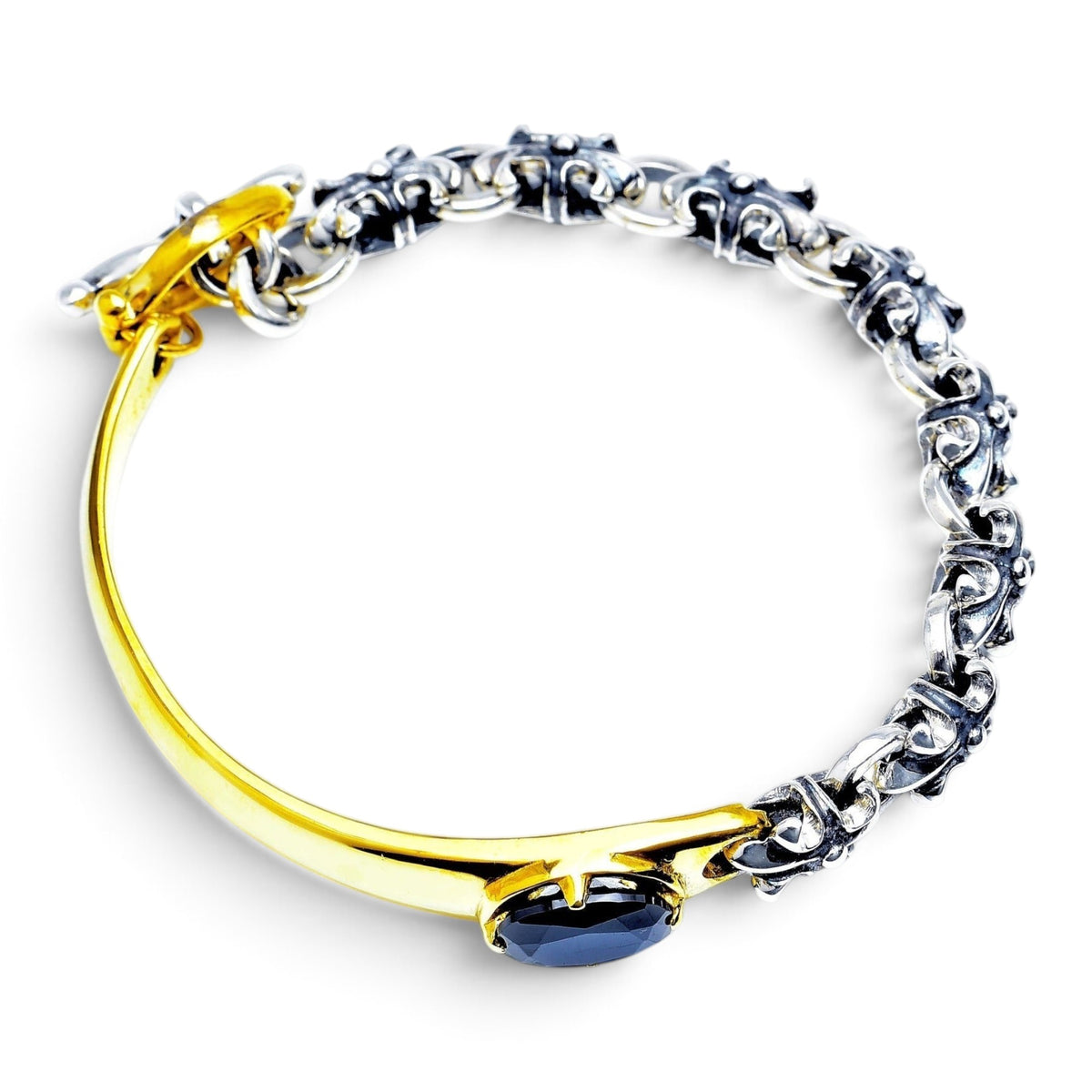 Truelements Jewelry two-tone bracelet featuring sterling silver fleur-de-lis links, brass, and a black cubic zirconia.