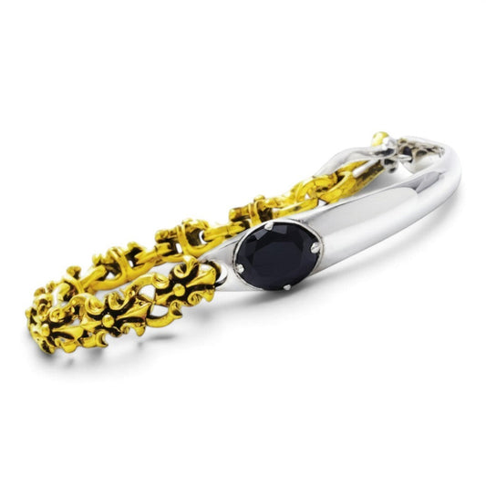 Truelements Jewelry two-tone bracelet featuring gold brass fleur-de-lis links, sterling silver, and black zirconia.