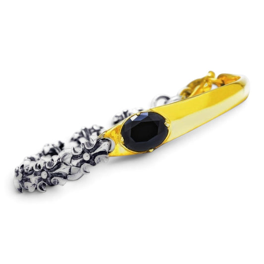 Truelements Jewelry two-tone bracelet in sterling silver and brass with a black oval cubic zirconia and fleur-de-lis