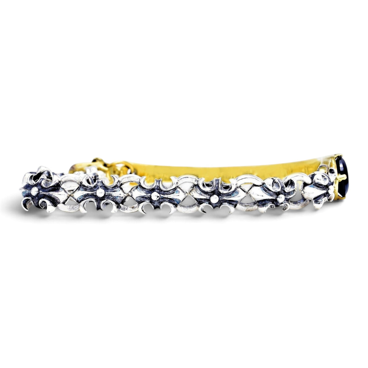 Truelements Jewelry two-tone bracelet in sterling silver and brass with fleur-de-lis links and black cubic zirconia.