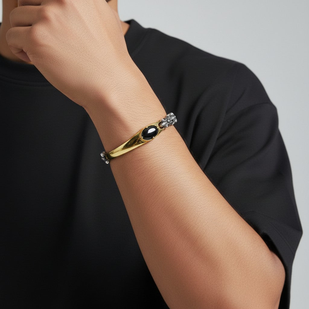 Truelements two-tone bracelet in sterling silver and brass featuring an oval black cubic zirconia on a wrist