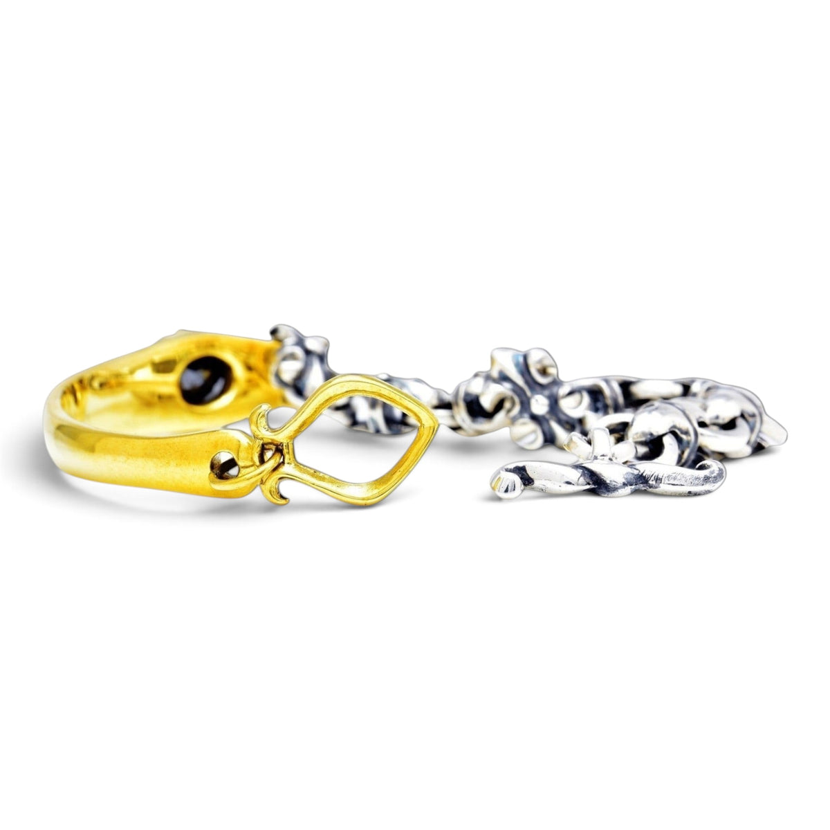 Truelements Jewelry two-tone bracelet in sterling silver and brass with fleur-de-lis links and black cubic zirconia