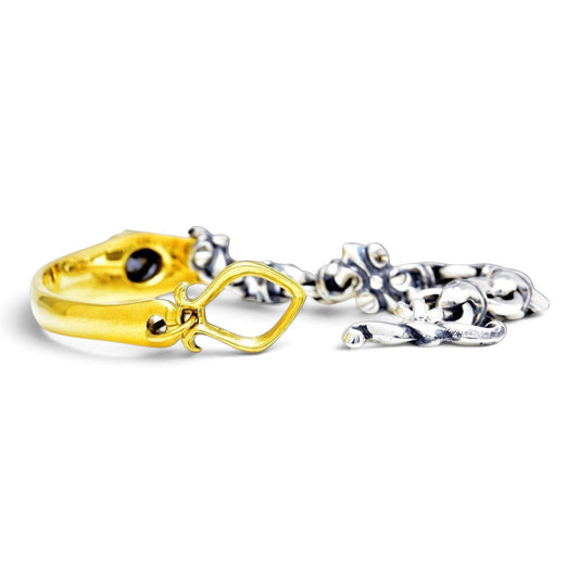 Truelements Jewelry two-tone bracelet in sterling silver and brass with fleur-de-lis links and black cubic zirconia